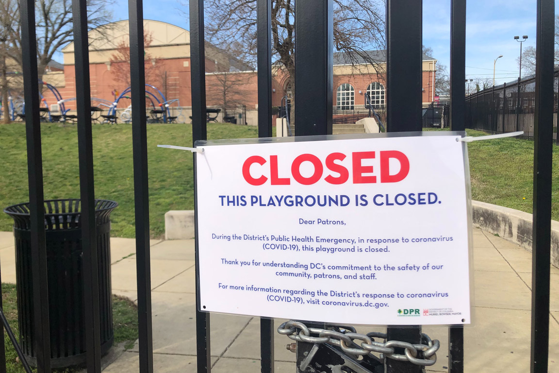 A sign marking a playground closed due to COVID-19 in Washington D.C.