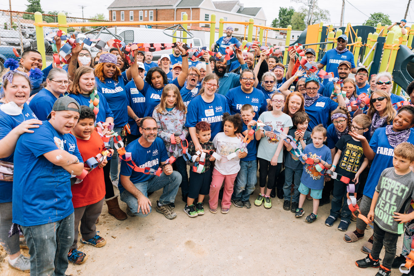 Kids and volunteers celebrate the completion of their community-built playground at Maree G. Farring Elemementary Middle School in Baltimore, MD