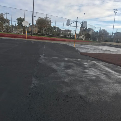 Franklin Elementary's current playspaces with blacktop and rimless backboards