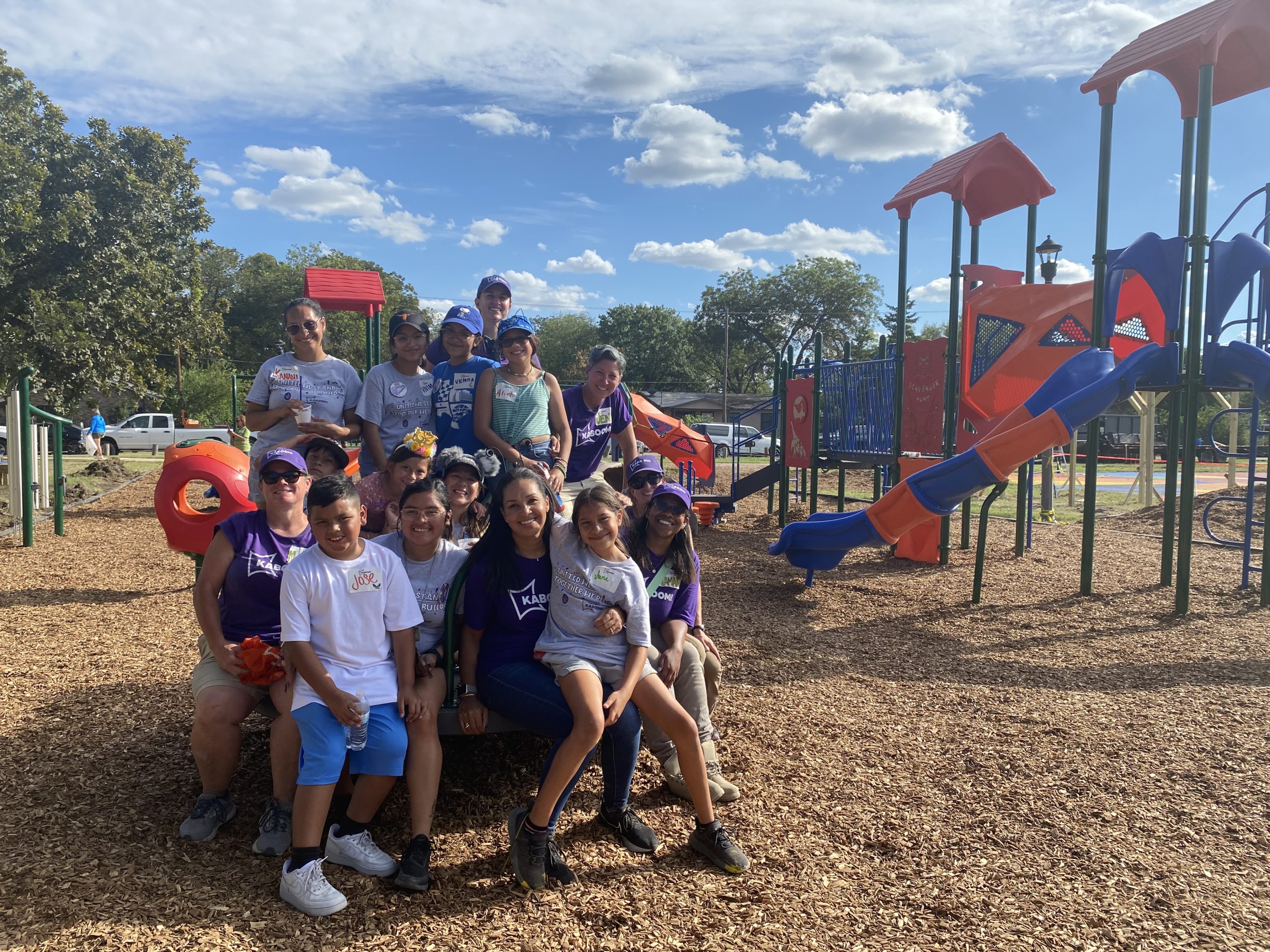 group picture in front of completed playground in Uvalde Texas