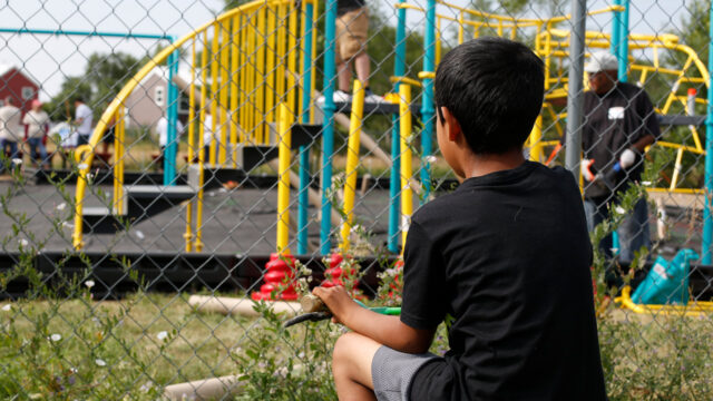 kid-on-bike-watches-a-playground-get-built