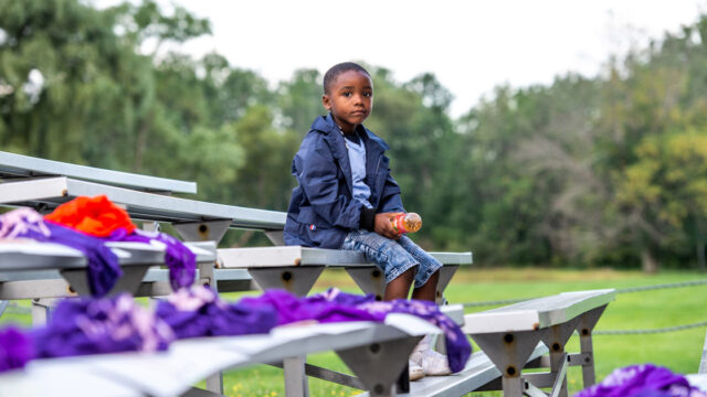 boy-sits-on-bleachers-og